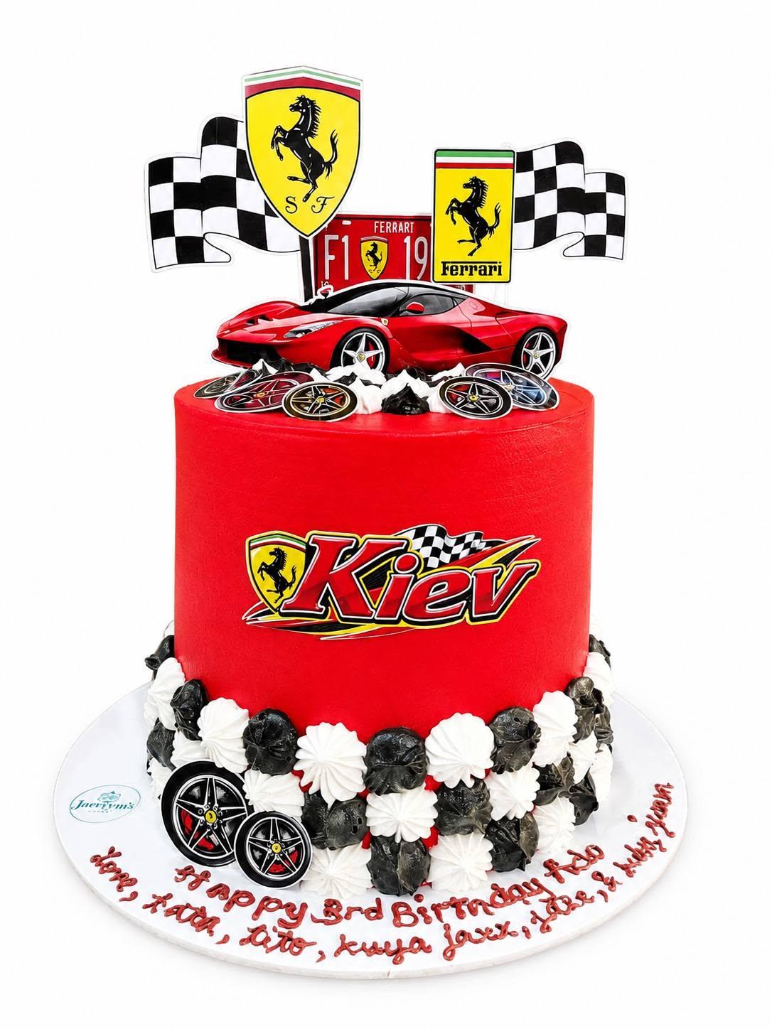 A red Ferrari-themed birthday cake with checkered flags for a 3rd birthday named Kiev