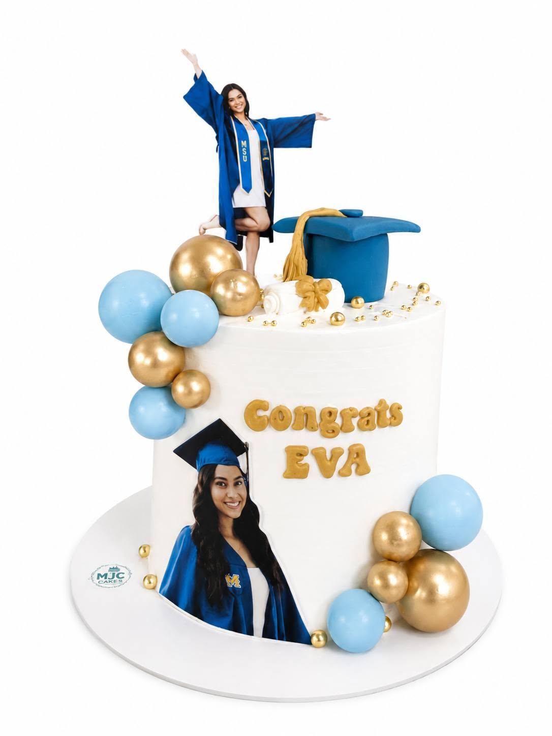 A white graduation cake with blue and gold balloons and a photo topper, reading Congrats Eva