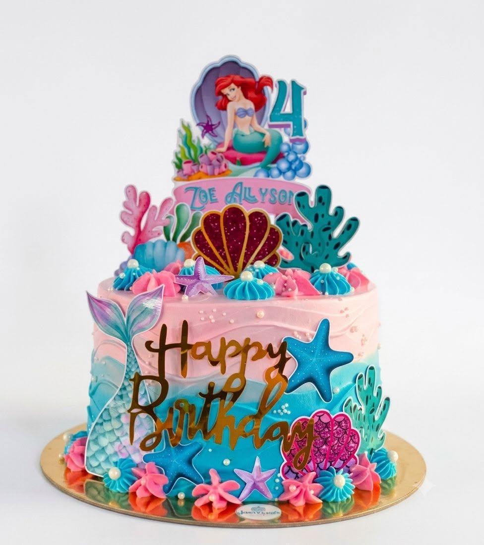 A pink and teal mermaid-themed cake with a starfish and gold script, made for Zoe Allyson's 4th birthday