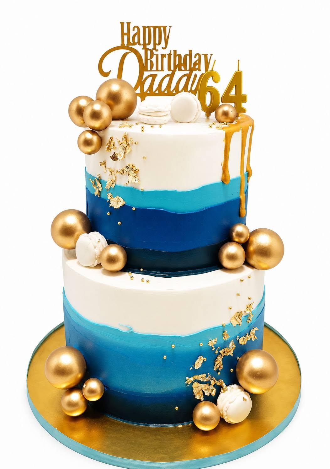 A two-tier blue ombre birthday cake with gold spheres and a gold drip, reading Happy Birthday Daddy 64
